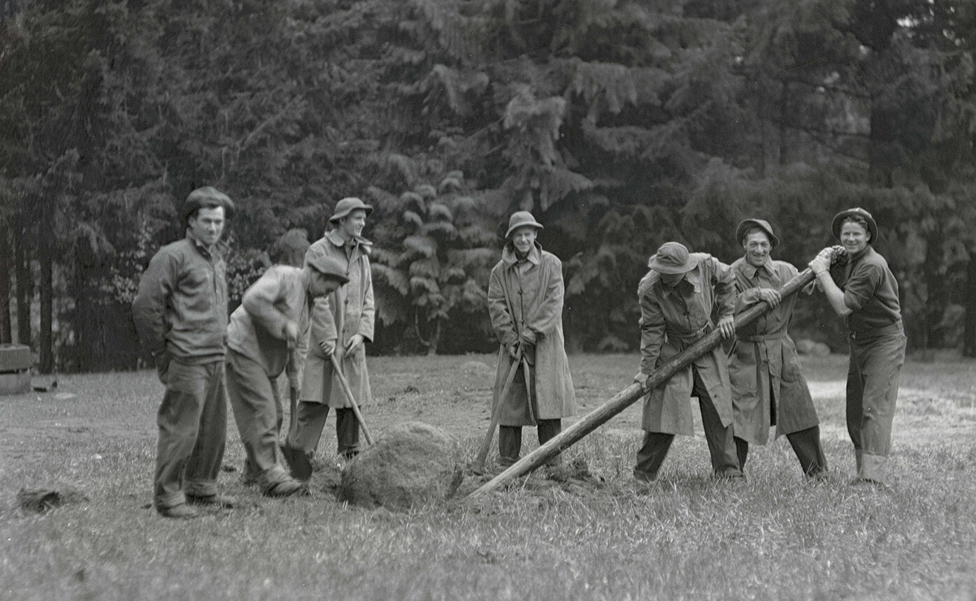 An old photograph of CCC workers digging a post hole