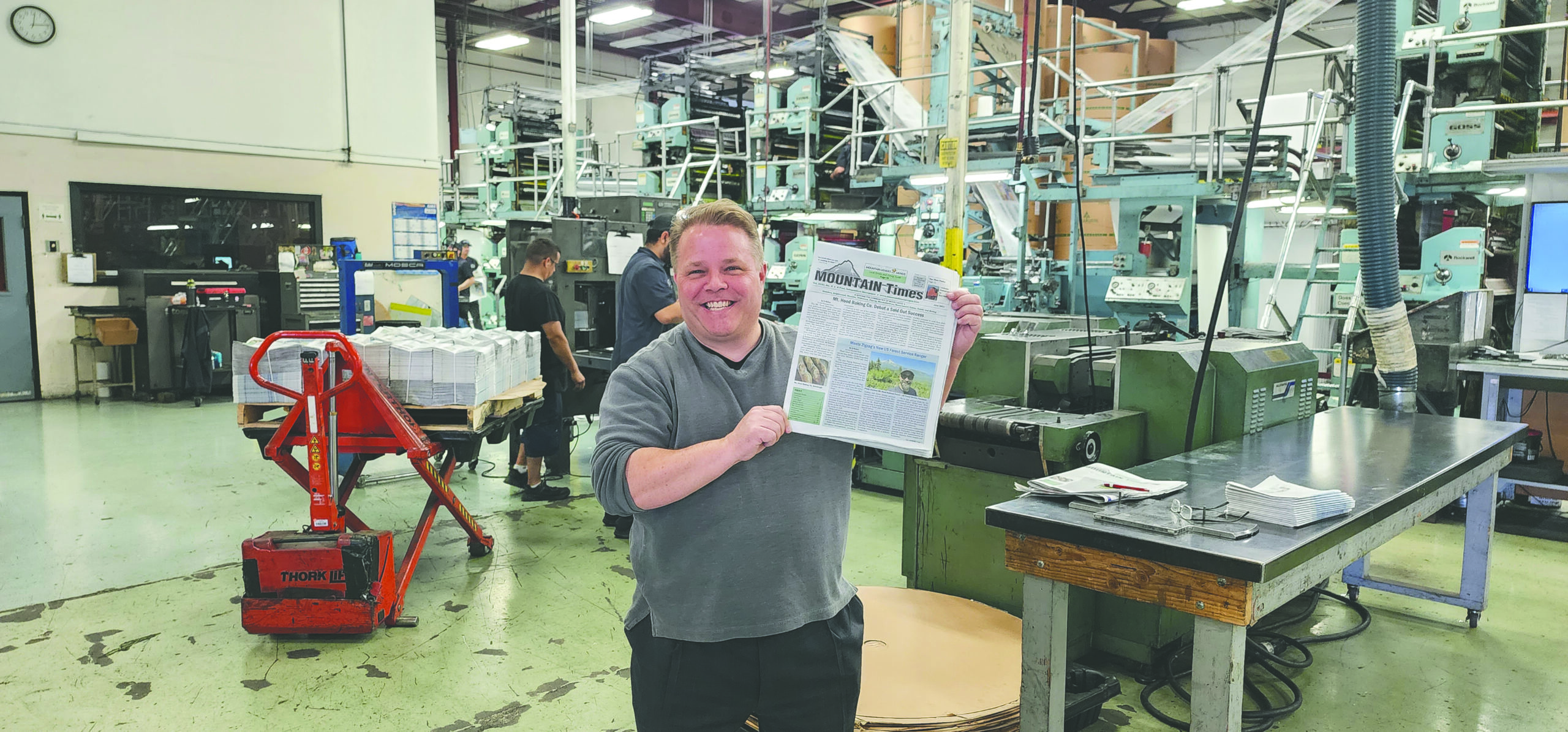 mat stands in front of the printers printing the mountain times