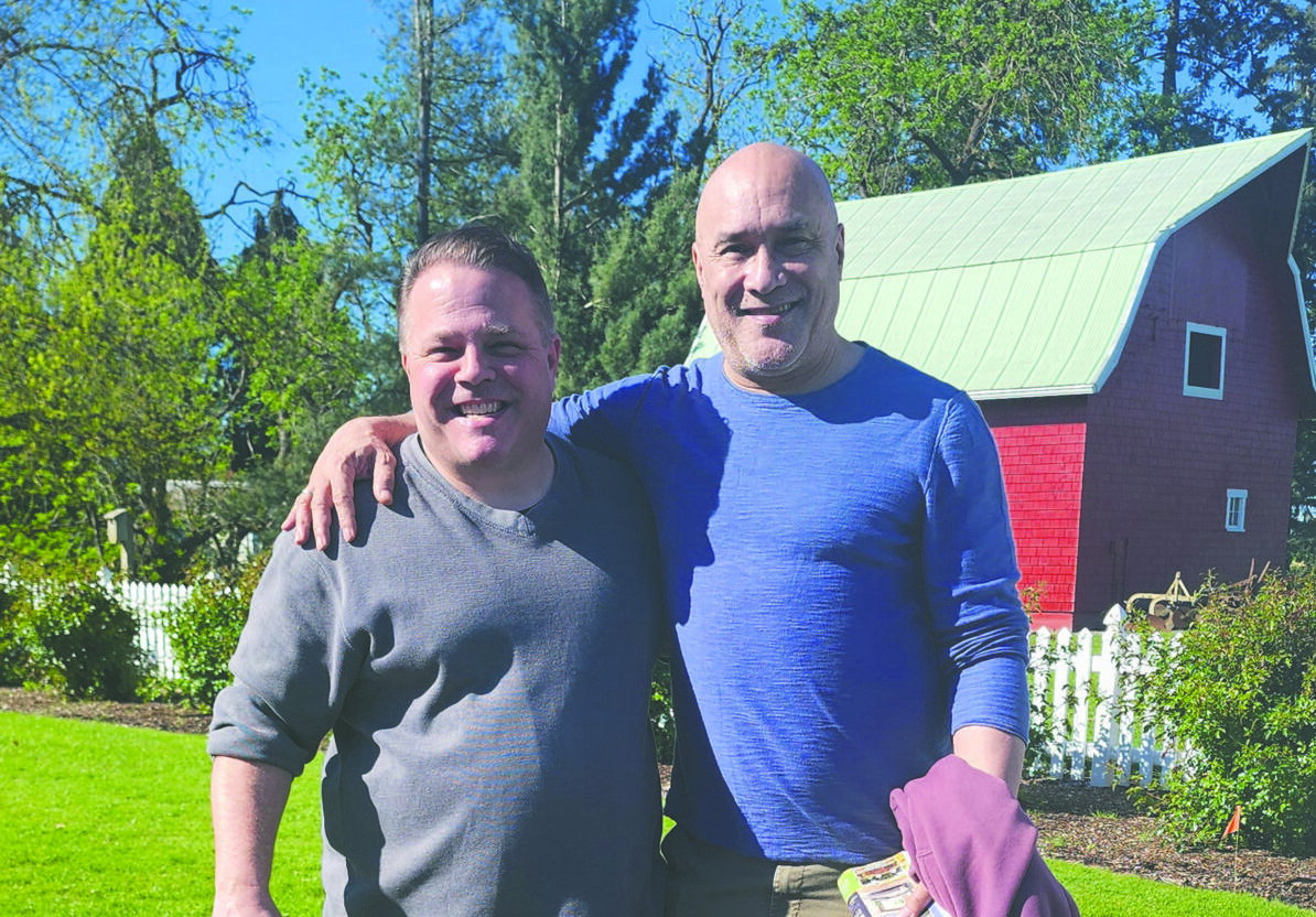 Publisher Matt and His friend, Dan reed have their arms over each others shoulders