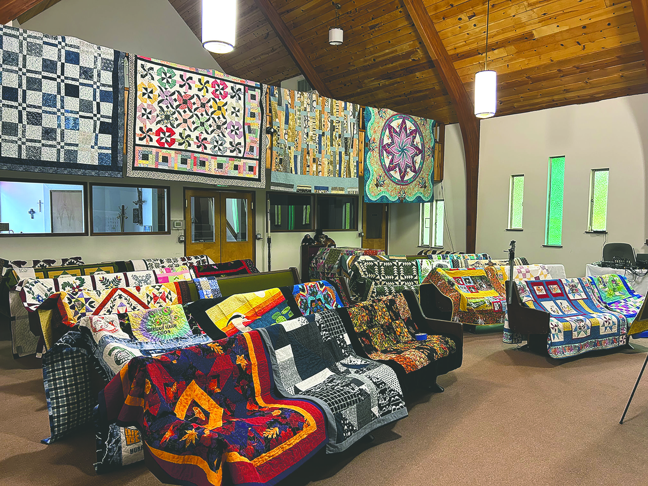 colorful quilts laid out over balconies and chairs