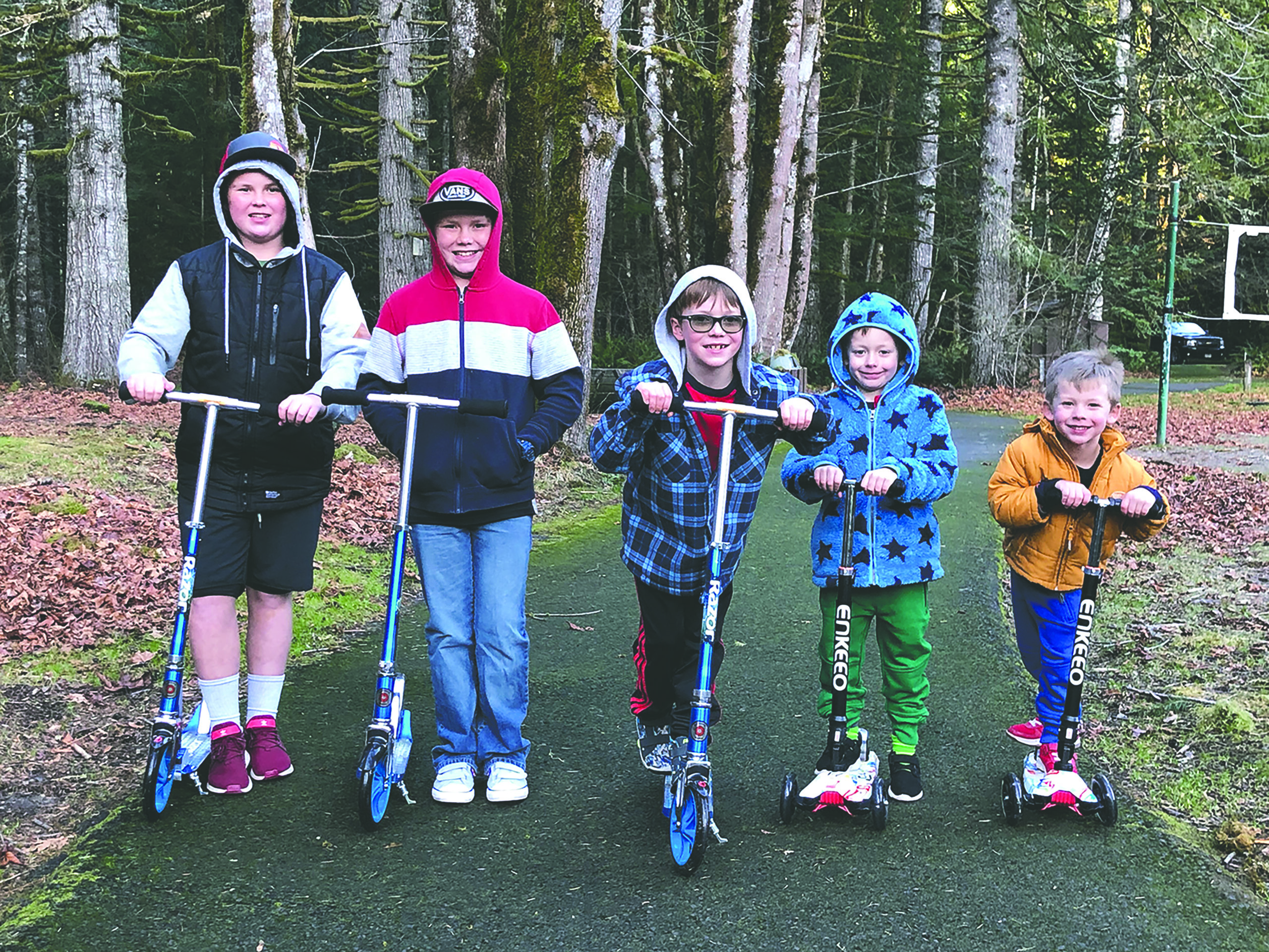 5 kids lined up on their scooters