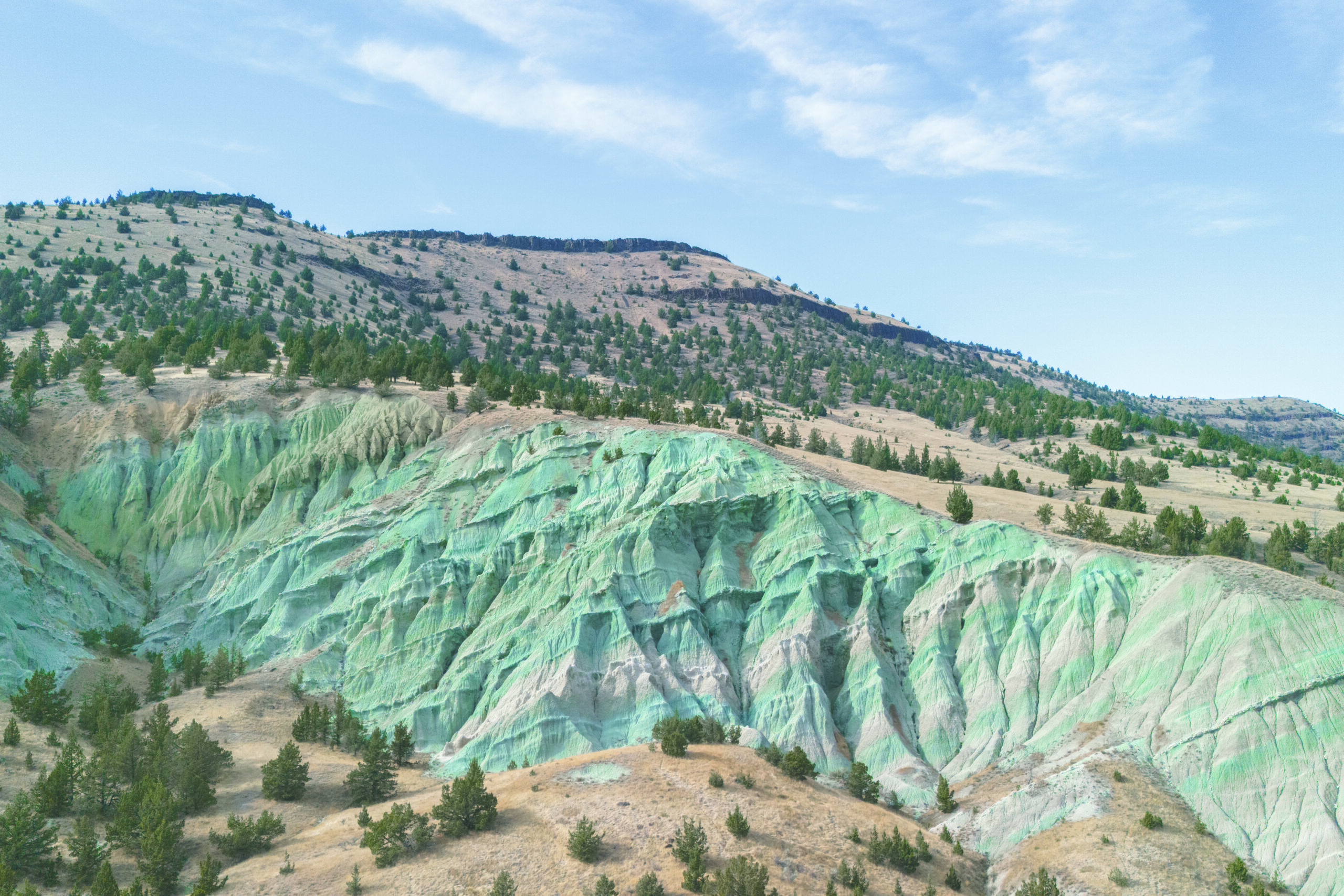 desert valleys and hills with a strip of green soil down the middle