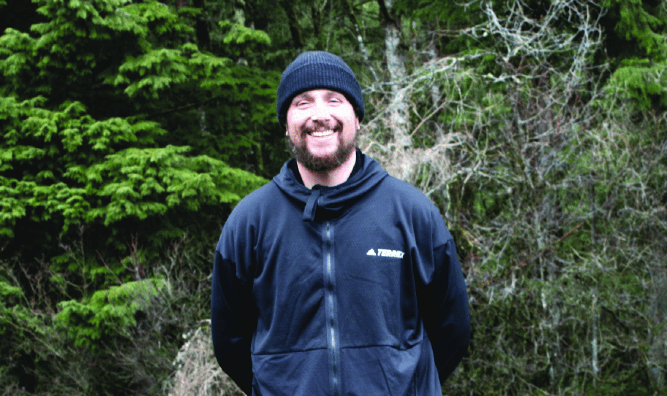 George Sandidas poses in front of a forest