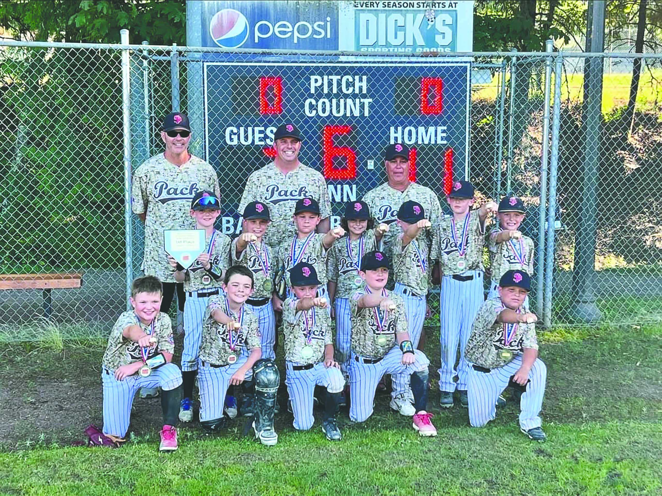 the kids baseball team pose together after a game