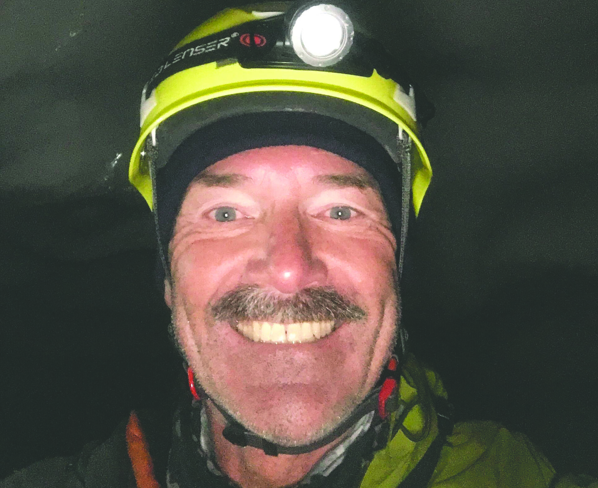 Firefighter Tom smiles for a picture in full gear