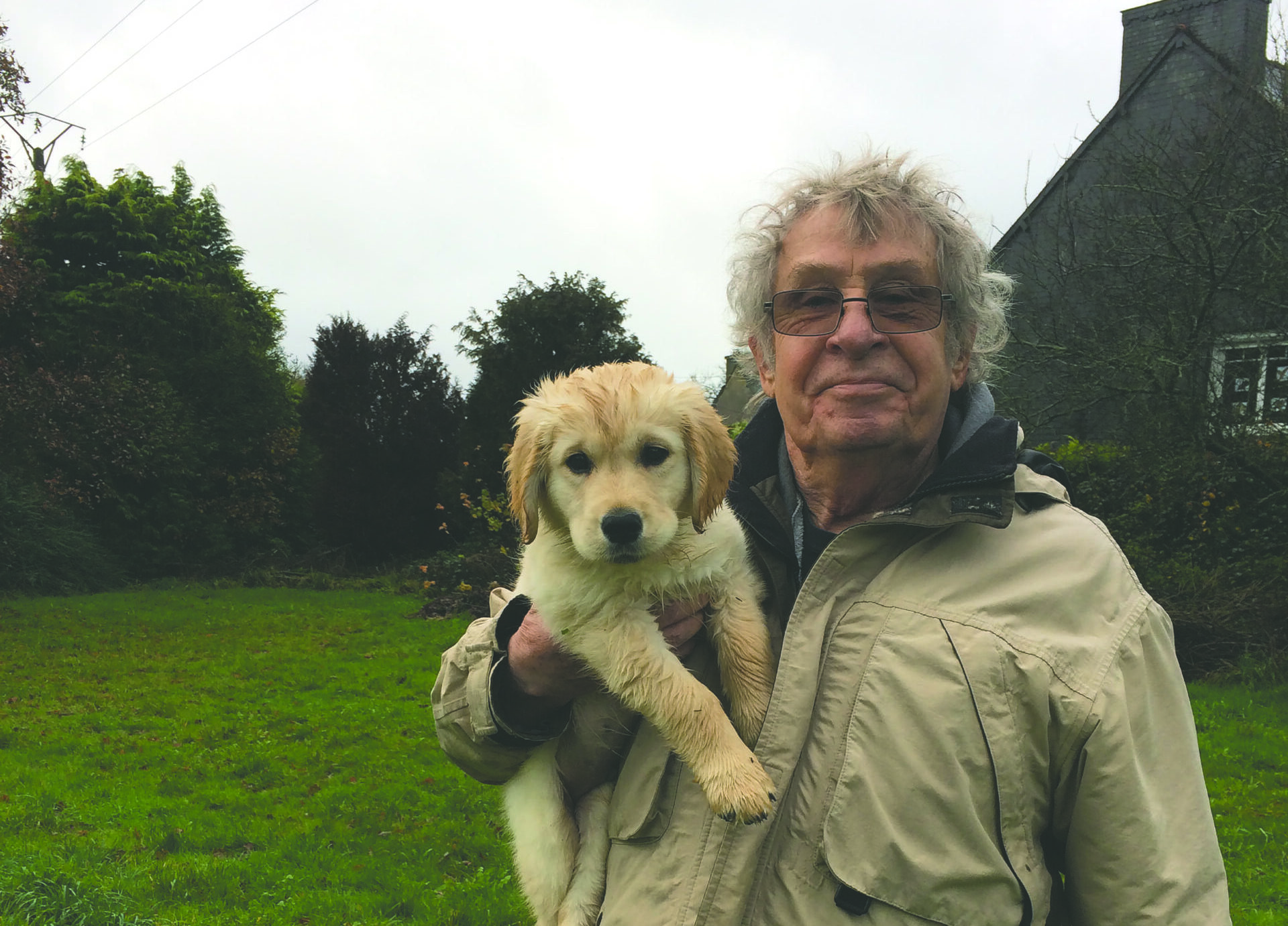 Larry holds his dog Higgins