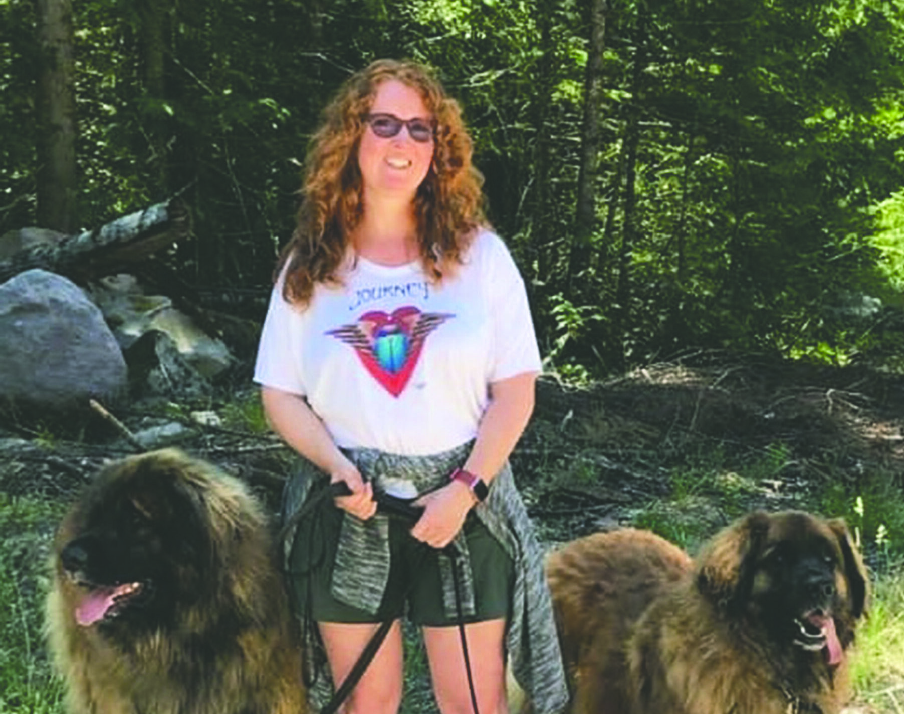 Laura on a forest hike with her two large dogs