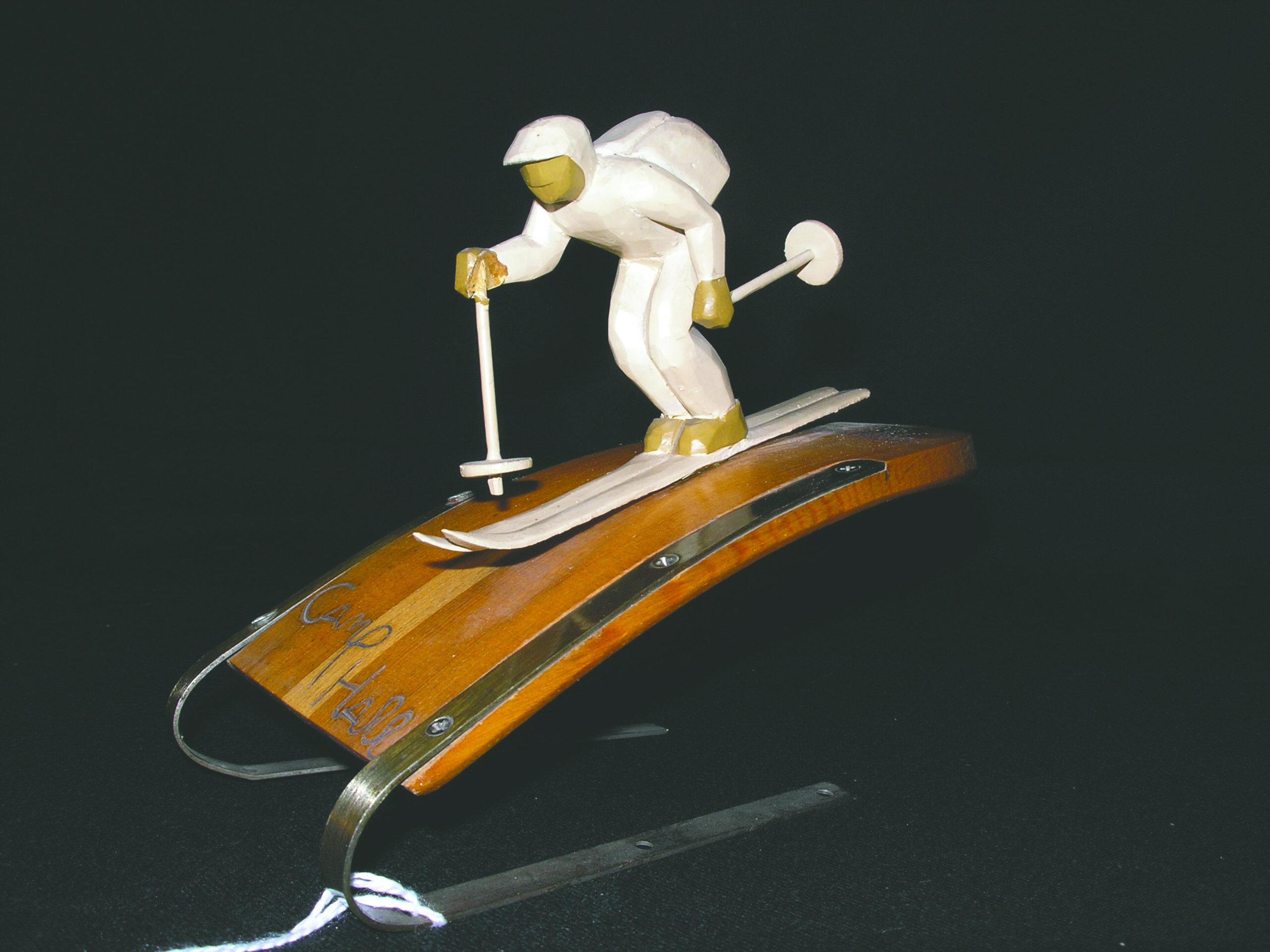 a wooden sculpture of a skier