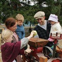 family gathers to press apples with their kids