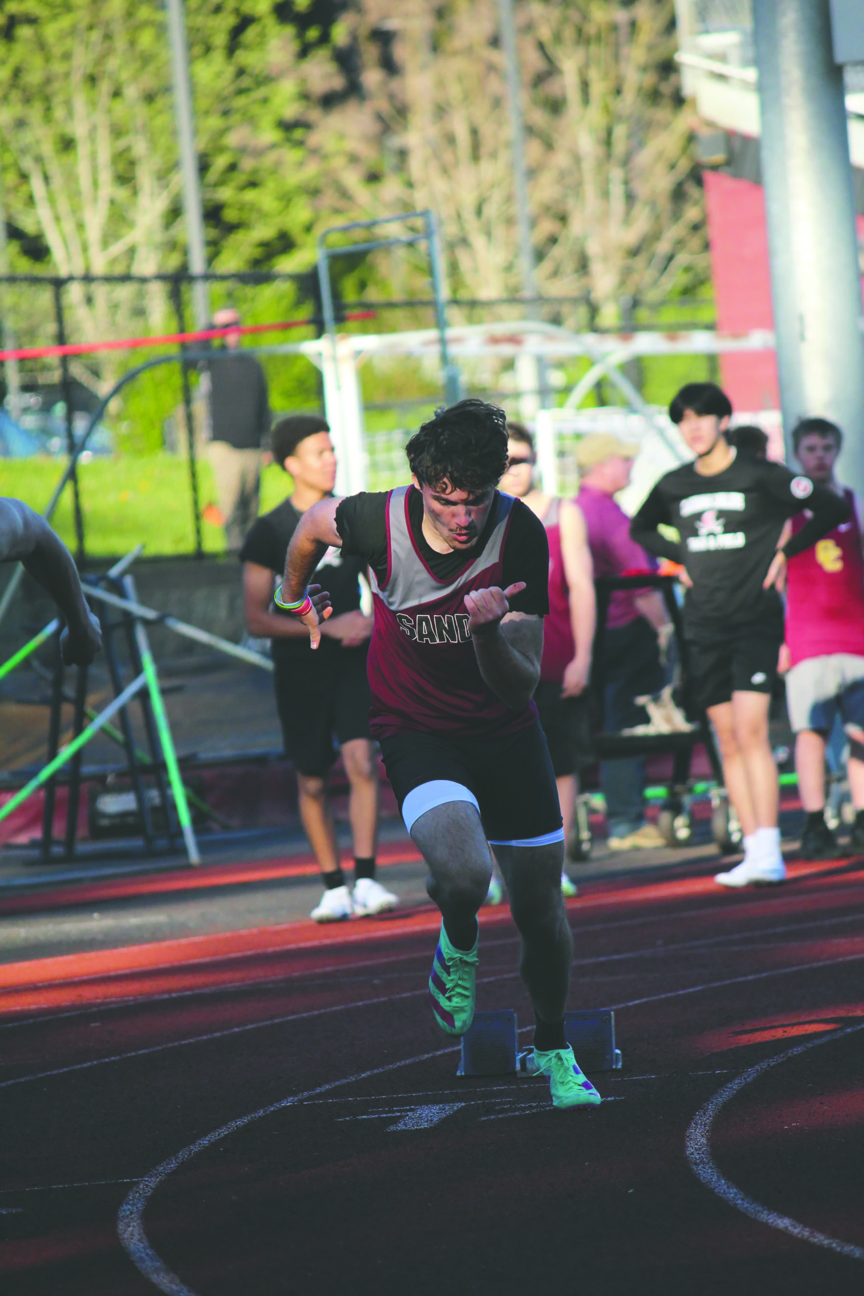 a skilled high school runner sprints from the start line