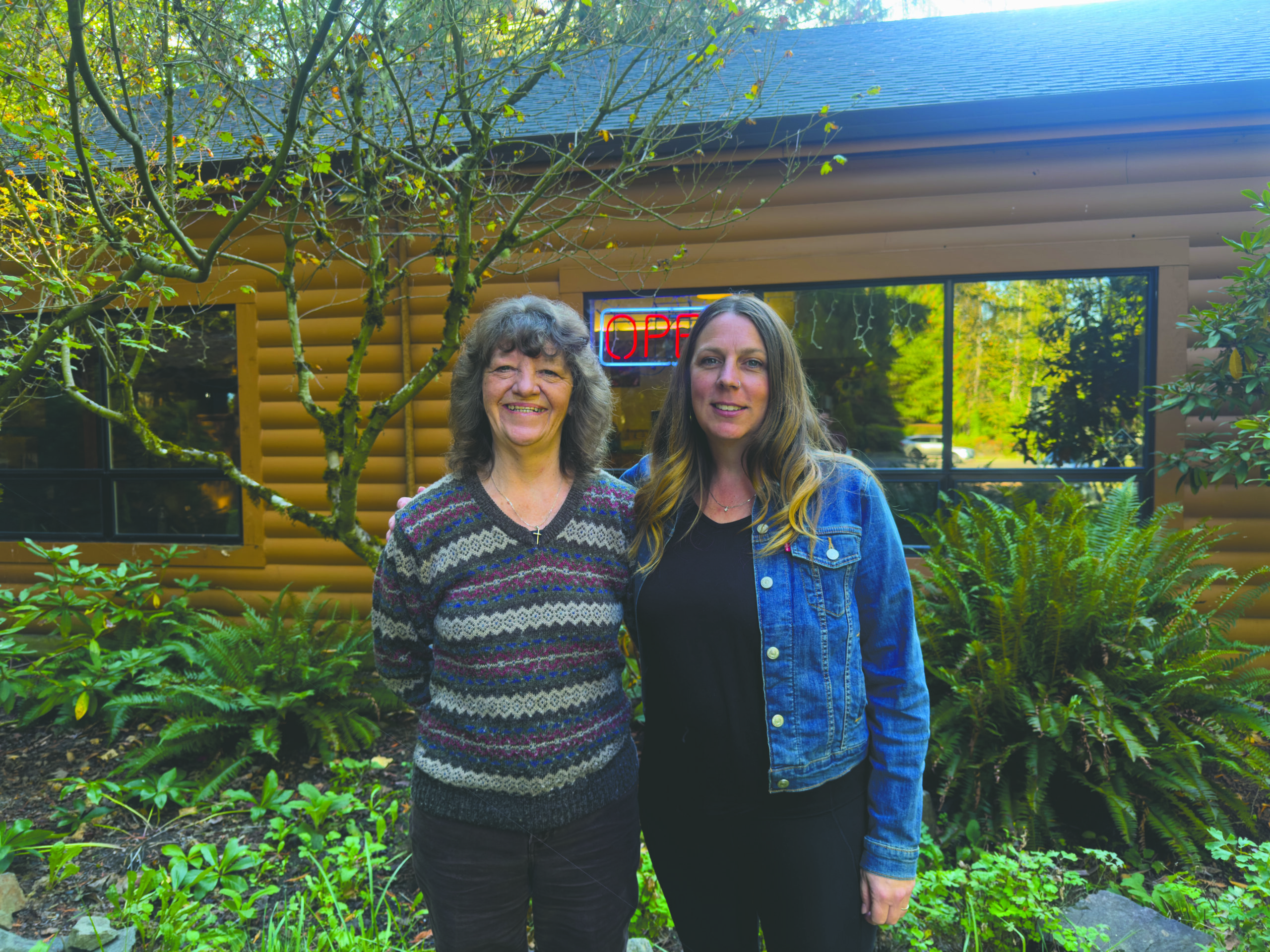 Two volunteers pose in front of Hoodland Senior Center