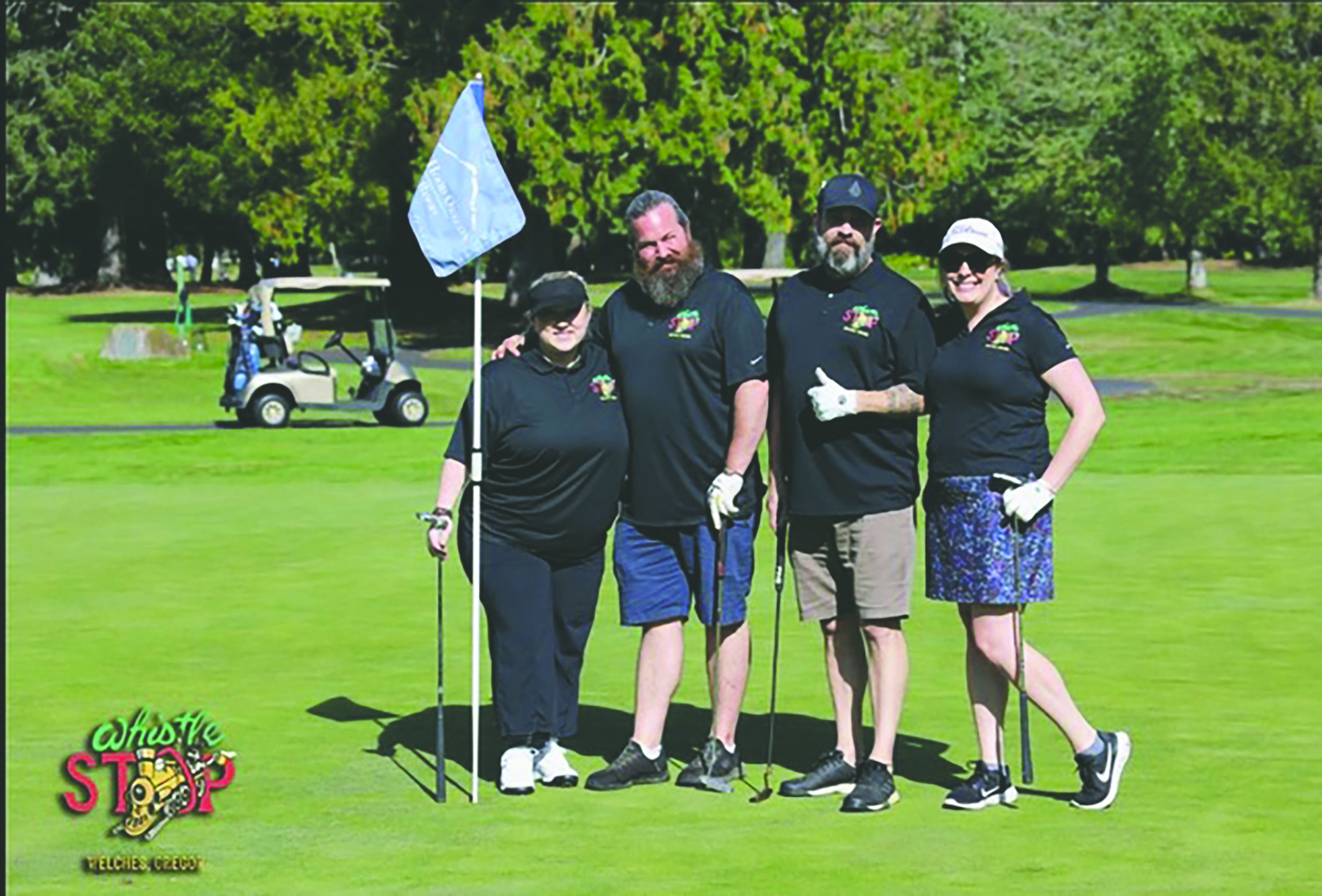 Golfers pose at the last hole