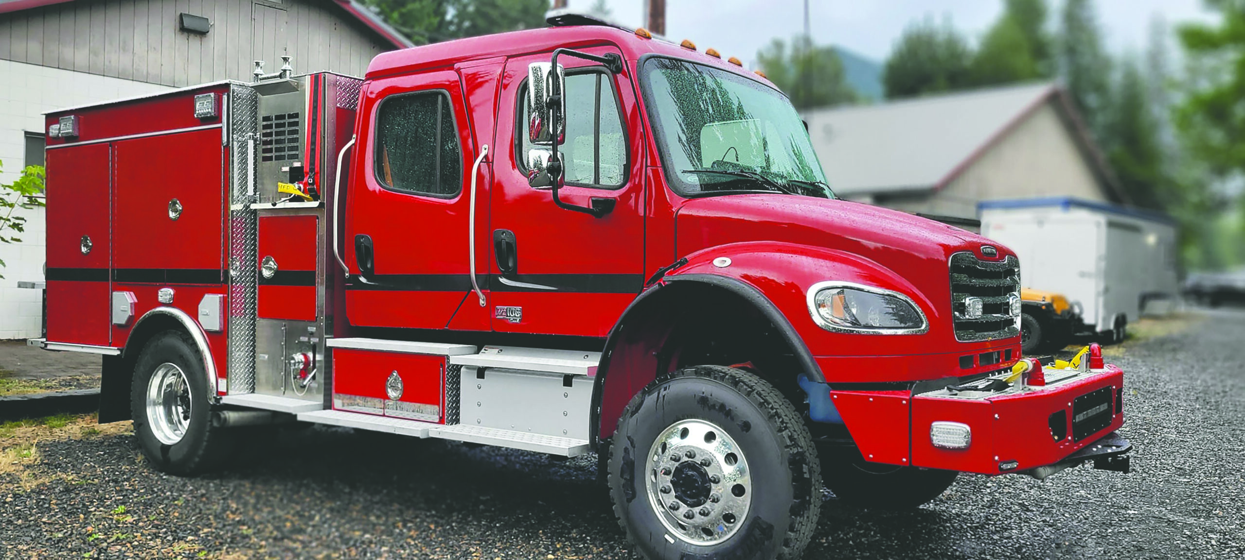 a new Fire engine parked in front of the fire station