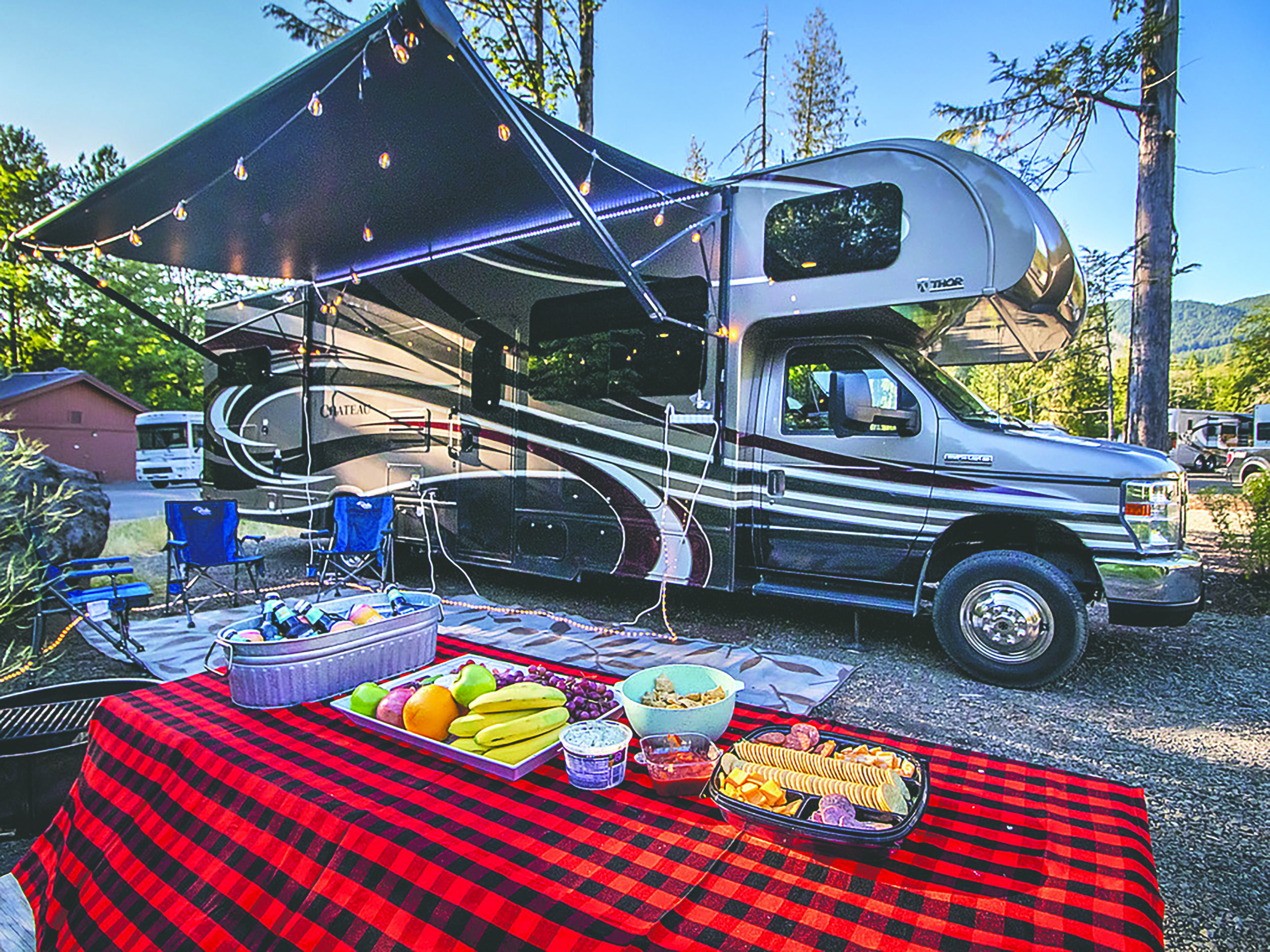 A camper is set up with a spread of snacks