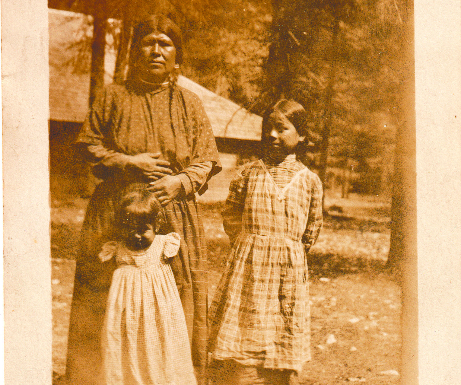 Old photo of a native family with the hand written message "Summer Visitors at Brightwood"